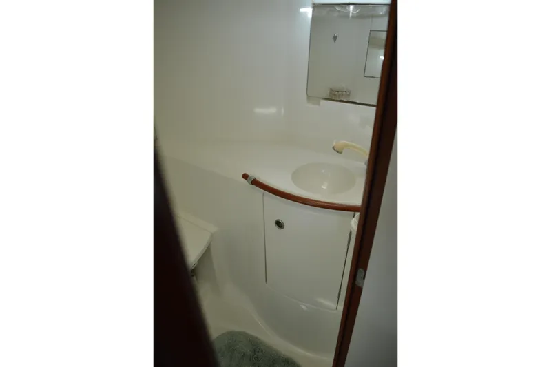 Slide: The Image of Bathroom interior of 1999 Beneteau 411 yacht, featuring sink and mirror. - 45