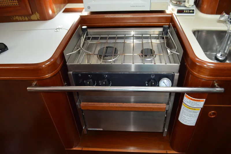 Slide: The Image of Galley stove in 1999 Beneteau 411 yacht, featuring dual burners and stainless steel finish. - 30