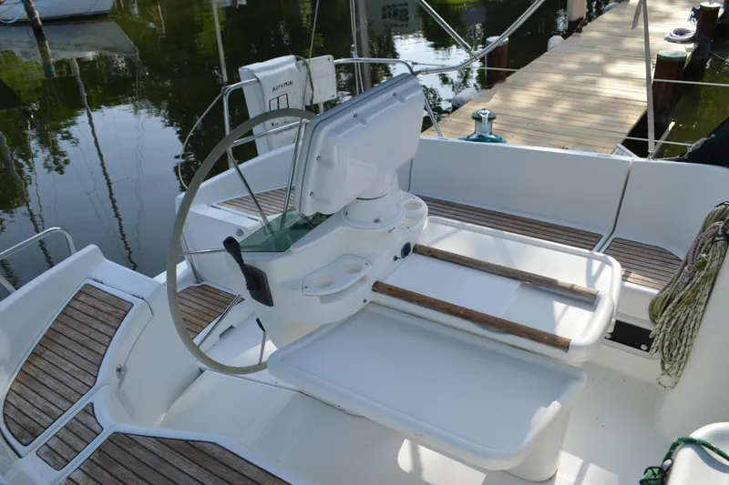 Slide: The Image of Cockpit of 1999 Beneteau 411 sailboat with steering wheel and seating area. - 15