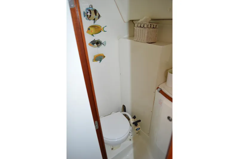 Slide: The Image of Compact bathroom in a 1999 Beneteau 411 sailboat with nautical decor. - 37