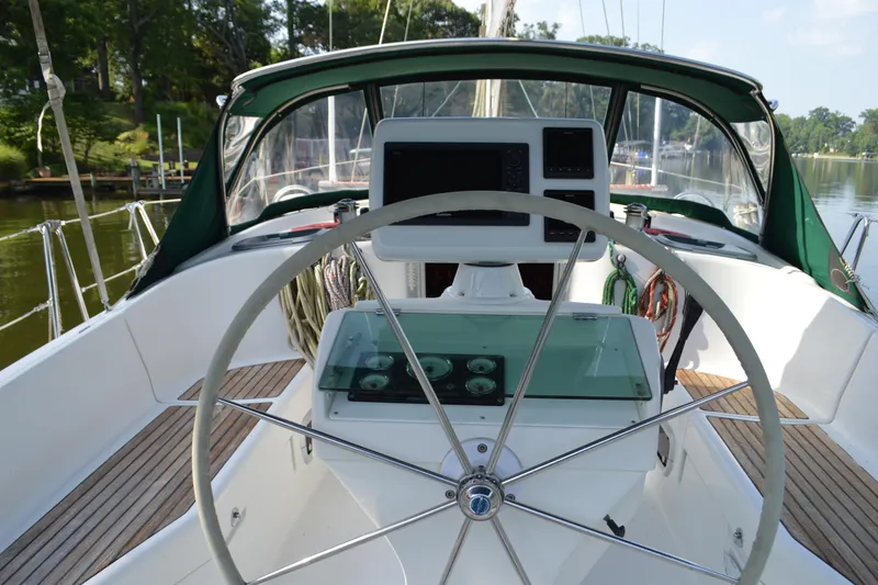 Slide: The Image of Cockpit of a 1999 Beneteau 411 sailboat with steering wheel and navigation instruments. - 11