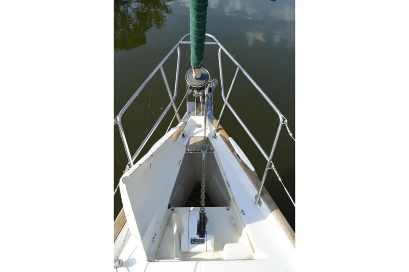 Slide: The Image of Bow of 1999 Beneteau 411 sailboat with anchor chain and railing. - 7