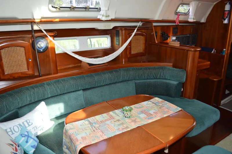 Slide: The Image of Interior of a 1999 Beneteau 411 yacht with cozy seating and wooden finishes. - 26