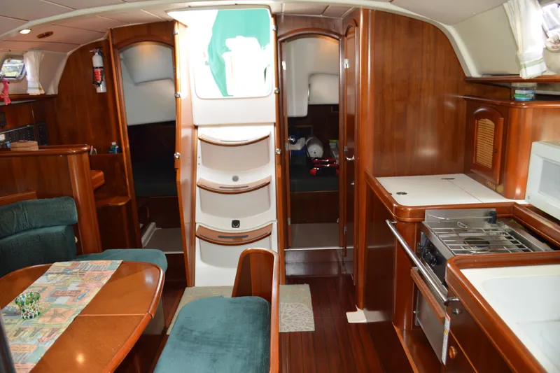 Slide: The Image of Interior of a 1999 Beneteau 411 yacht with wood finish and compact kitchen. - 22