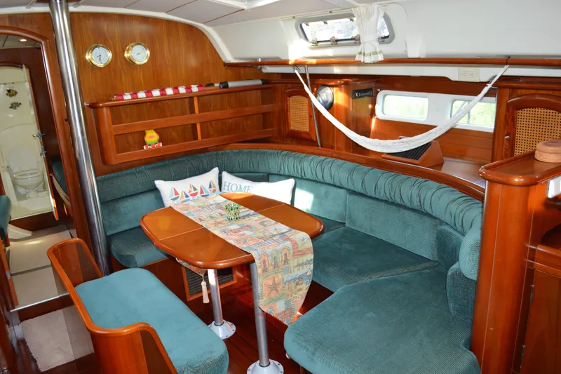 Slide: The Image of Interior of a 1999 Beneteau 411 yacht with cozy seating and wooden finishes. - 23