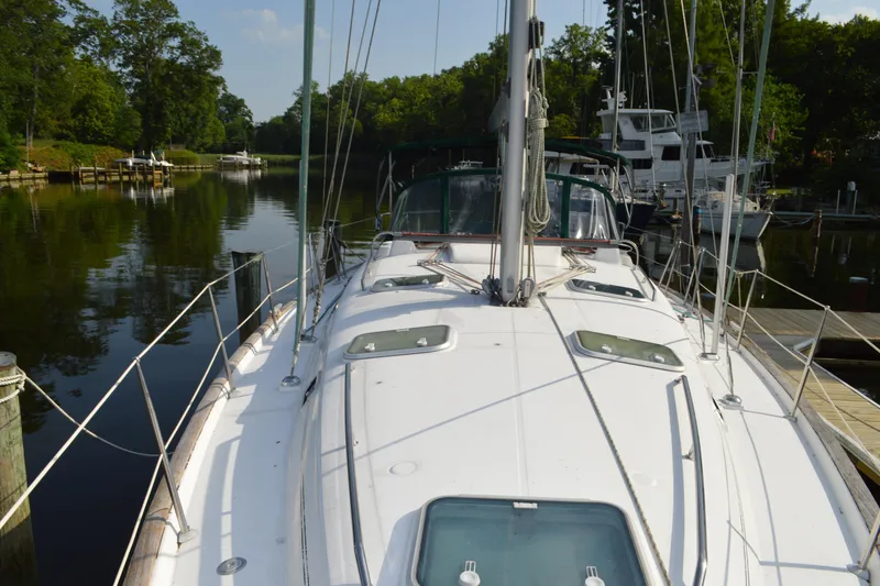Slide: The Image of Sailing yacht Beneteau 411, 1999 model, docked in a serene marina setting. - 5
