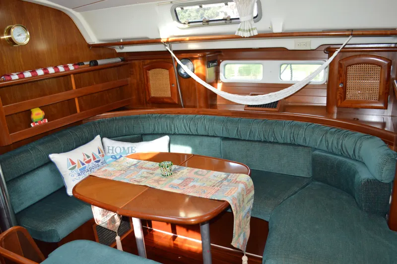 Slide: The Image of Interior of 1999 Beneteau 411 yacht with cozy seating and nautical decor. - 25