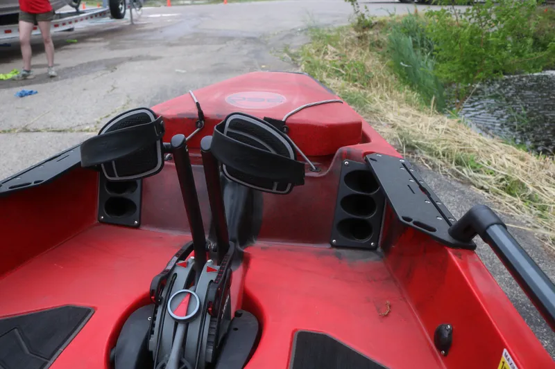Slide: The Image of Red 2023 Hobie Mirage Pro Angler 14 kayak with pedal drive system, docked near water. - 11
