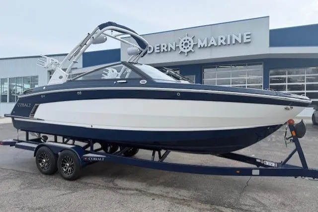 The Image of 2026 Cobalt R6 Surf boat on trailer outside Modern Marine dealership. - 1