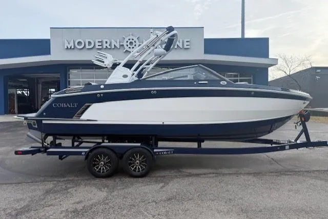 Slide: The Image of 2026 Cobalt R6 Surf boat on trailer outside Modern Marine dealership. - 4