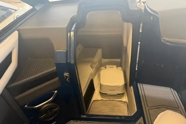 Slide: The Image of 2026 Cobalt R6 Surf boat interior with compact storage compartment and modern design. - 10