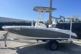 Slide: The Image of 2016 Yamaha Boats 190 FSH Sport on trailer, parked outdoors under clear blue sky. - 5