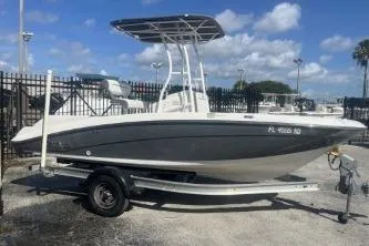 The Image of 2016 Yamaha Boats 190 FSH Sport on trailer, parked outdoors under blue sky. - 1