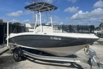 Slide: The Image of 2016 Yamaha Boats 190 FSH Sport on trailer, parked outdoors under blue sky. - 2