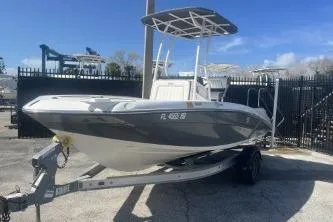 Slide: The Image of 2016 Yamaha Boats 190 FSH Sport on trailer, parked outdoors under clear blue sky. - 4