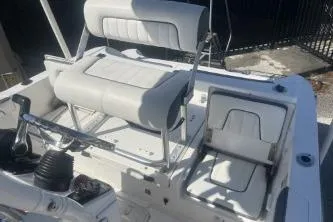 Slide: The Image of 2016 Yamaha Boats 190 FSH Sport interior seating and controls in sunlight. - 10
