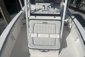 Slide: The Image of 2016 Yamaha Boats 190 FSH Sport interior with white seating and steering console. - 9