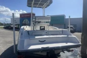 Slide: The Image of 2016 Yamaha Boats 190 FSH Sport, rear view, parked outdoors under clear sky. - 6