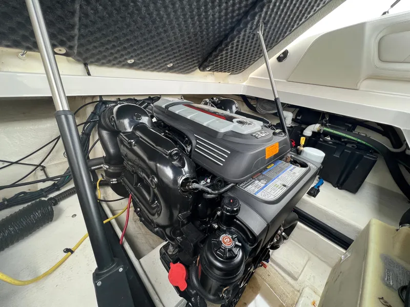 Slide: The Image of The engine compartment of a 2016 Chaparral 257 SSX shows a clean, well-maintained engine. - 32