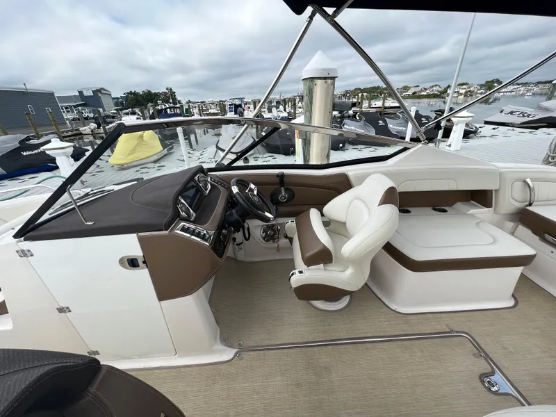 Slide: The Image of The image shows the cockpit of a 2016 Chaparral 257 SSX with beige and white seating. - 14