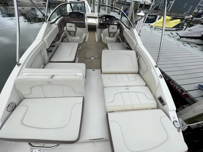 Slide: The Image of The image shows the interior of a 2016 Chaparral 257 SSX boat with white upholstery. - 24