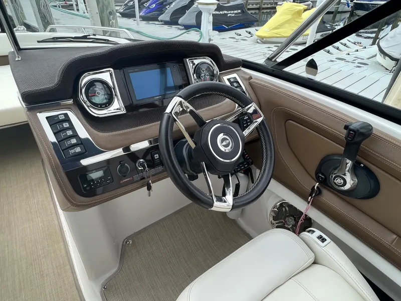 Slide: The Image of The image shows the cockpit of a 2016 Chaparral 257 SSX with a sleek steering wheel and modern instruments. - 48