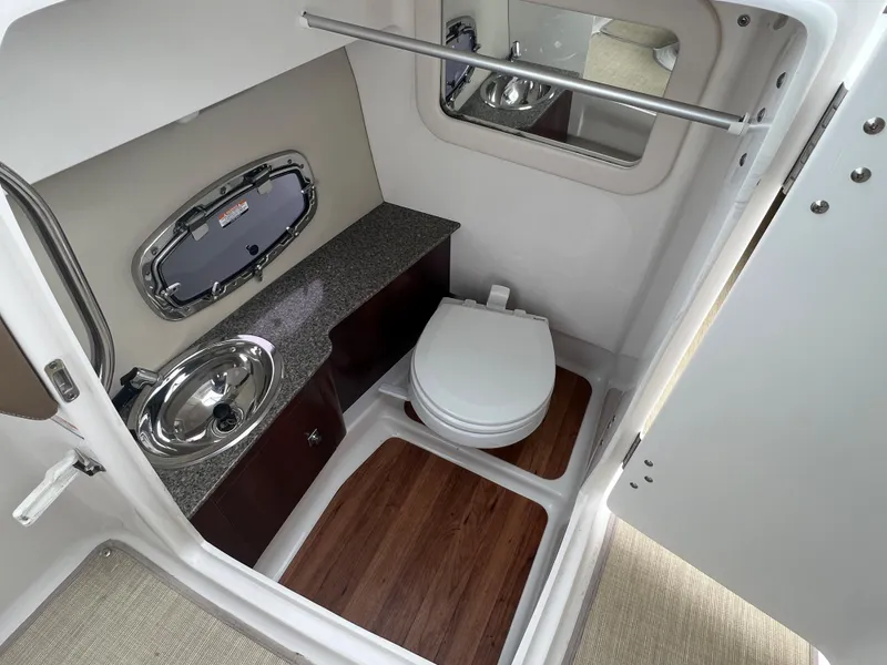Slide: The Image of Interior view of a boat bathroom with sink, toilet, and mirror. - 40