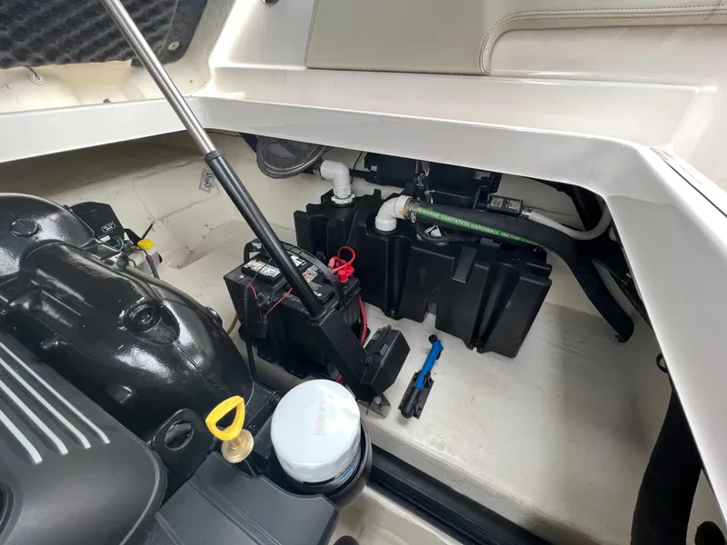 Slide: The Image of Engine compartment of a 2016 Chaparral 257 SSX boat with battery and hoses. - 33
