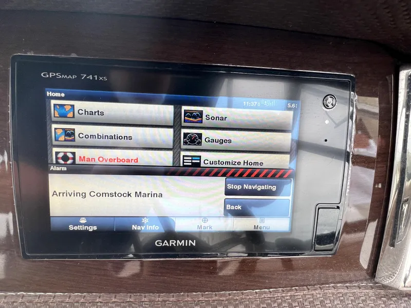 Slide: The Image of Garmin navigation system on a Chaparral 257 SSX boat, displaying arrival at Comstock Marina. - 43