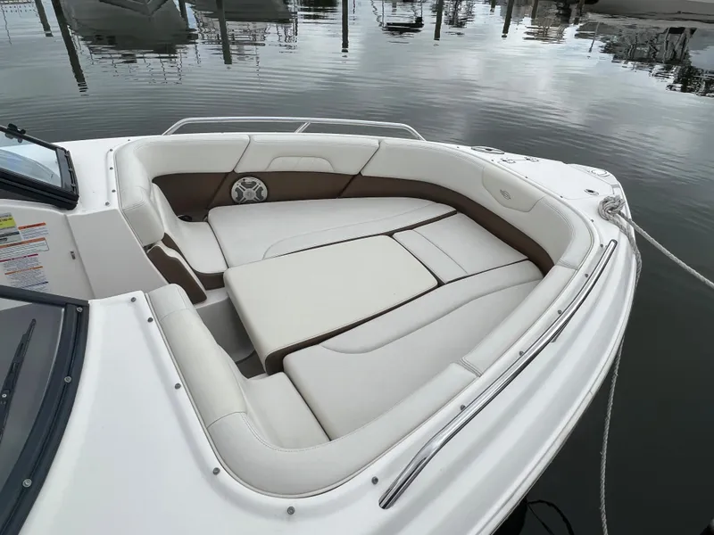 Slide: The Image of The image shows the bow area of a 2016 Chaparral 257 SSX boat with beige upholstery. - 18