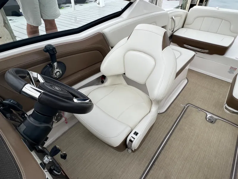 Slide: The Image of Interior of a Chaparral 257 SSX boat with beige carpet and white leather seating. - 41