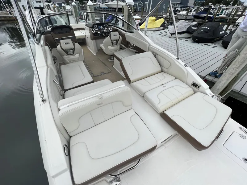 Slide: The Image of The image shows the cockpit of a 2016 Chaparral 257 SSX with white upholstered seats. - 25