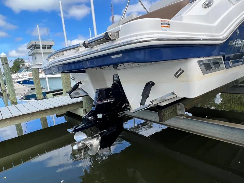 Slide: The Image of The image shows the stern of a 2016 Chaparral 257 SSX boat at a dock. - 8