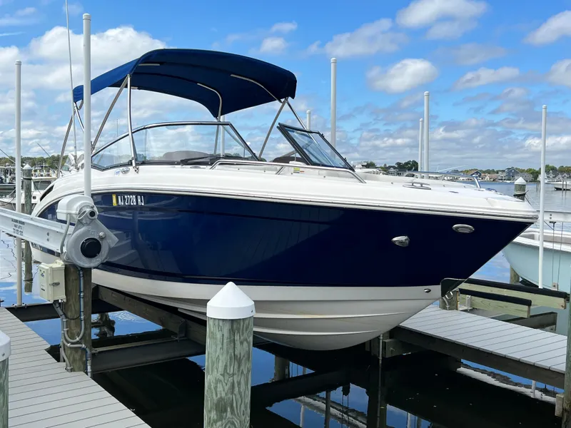 Slide: The Image of A blue and white 2016 Chaparral 257 SSX is docked on the water. - 6