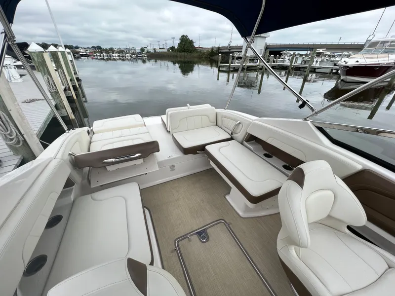 Slide: The Image of 2016 Chaparral 257 SSX with spacious cockpit and comfortable seating, docked by the water. - 26
