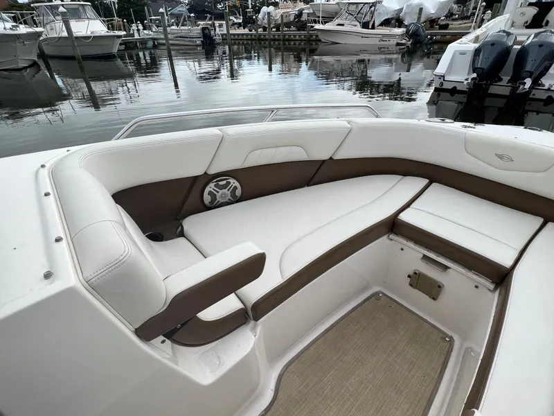 Slide: The Image of The image shows the bow area of a 2016 Chaparral 257 SSX boat with white and brown upholstery. - 16