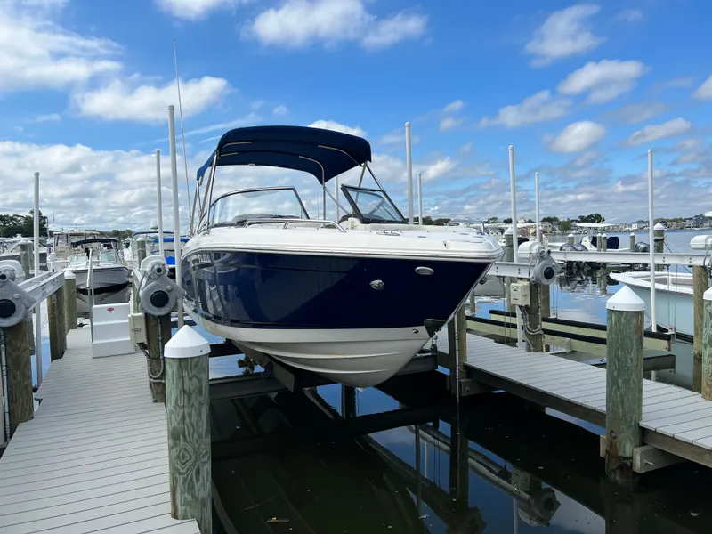 Slide: The Image of A 2016 Chaparral 257 SSX boat docked on the water. - 3