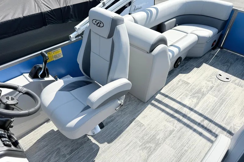 Slide: The Image of 2027 Bentley Pontoons Legacy 240 Navigator interior with plush seating and modern steering. - 8