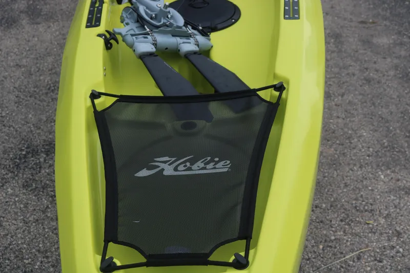 Slide: The Image of Yellow 2025 Hobie Mirage Compass kayak with pedal drive system on gravel surface. - 4