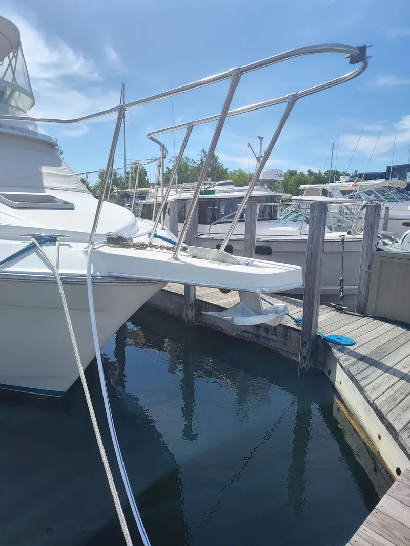 Slide: The Image of A 1989 Chris-Craft 372 Catalina docked. It features sleek design and stainless steel railings. - 33