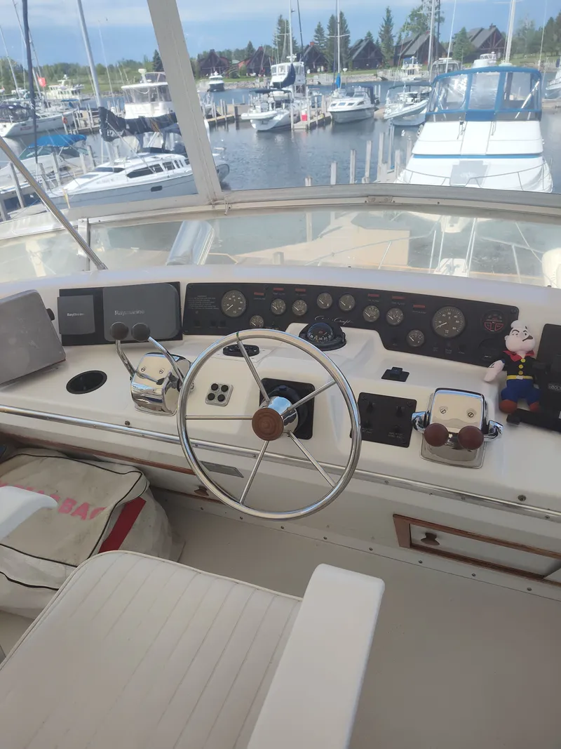 Slide: The Image of The cockpit of a 1989 Chris-Craft 372 Catalina with steering wheel and instrument panel. - 38