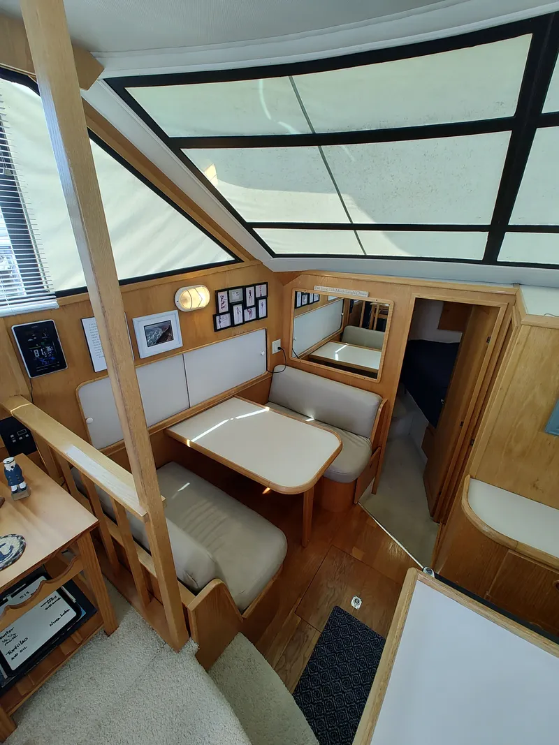 Slide: The Image of Interior of the 1989 Chris-Craft 372 Catalina featuring a dining area and wood finishes. - 47