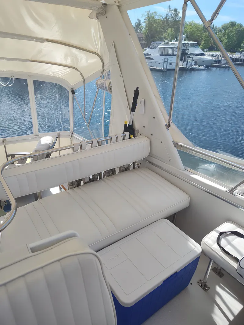 Slide: The Image of The image shows the cockpit of a 1989 Chris-Craft 372 Catalina with white seating and a blue cooler. - 39