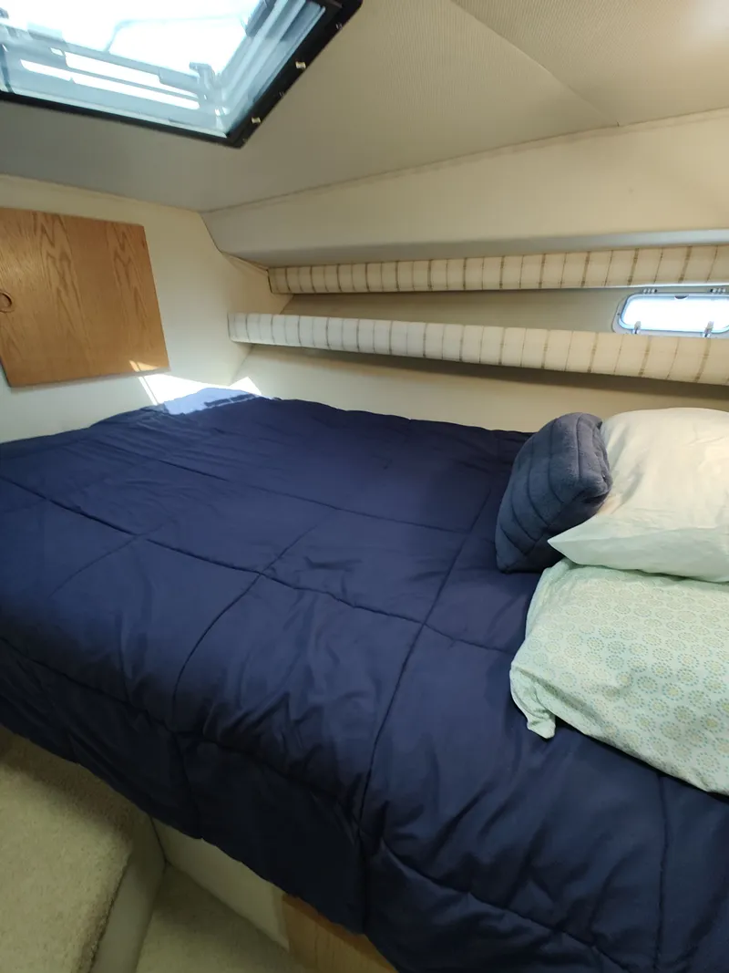 Slide: The Image of Cabin with blue bedding and window, Chris-Craft Catalina 1989. - 19