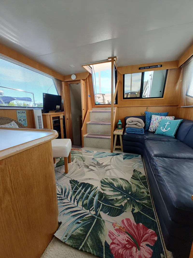 Slide: The Image of Interior of a 1989 Chris-Craft Catalina with cozy sofa and stairs. - 21