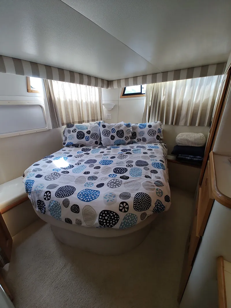 Slide: The Image of Cabin with a cozy double bed, striped curtains, and soft carpeting. - 24