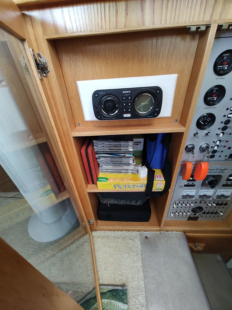Slide: The Image of A wooden cabinet with a Sony radio, CDs, and a game. Control panels are visible beside it. - 13