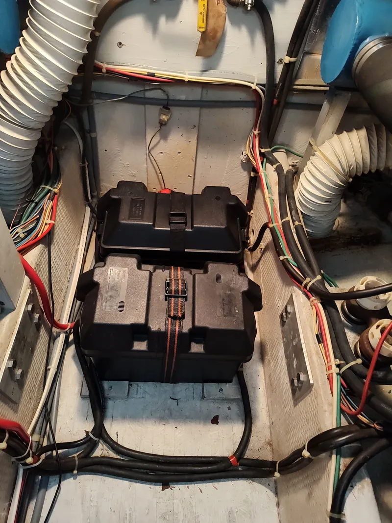 Slide: The Image of Battery compartment of a 1989 Chris-Craft Catalina boat with cables and hoses. - 30