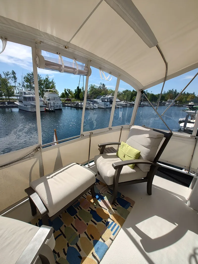 Slide: The Image of A cozy seating area on a boat overlooking a tranquil marina. - 5