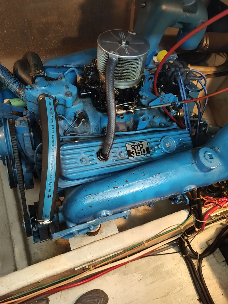 Slide: The Image of A blue-painted engine in a boat, with visible wires and hoses. - 28